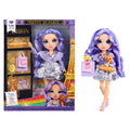 Doll with purple hair and outfit next to its packaging featuring the Eiffel Tower.